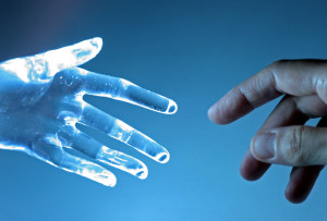 Human hand touch an atrifical glass hand